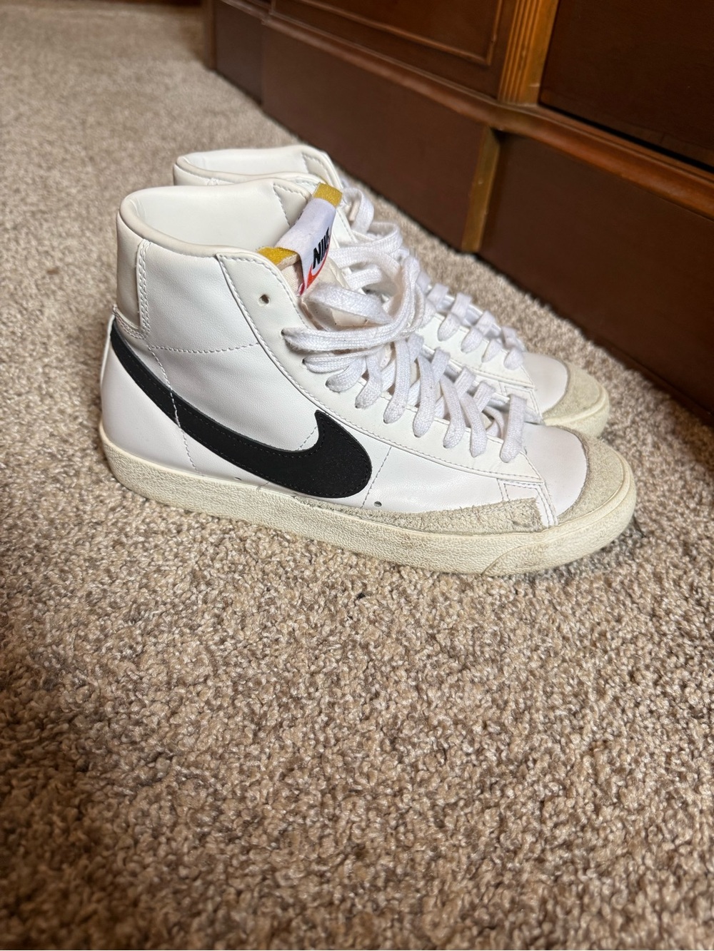 Nike White High-Top Sneakers with Black Swoosh and Yellow Tongue Tab